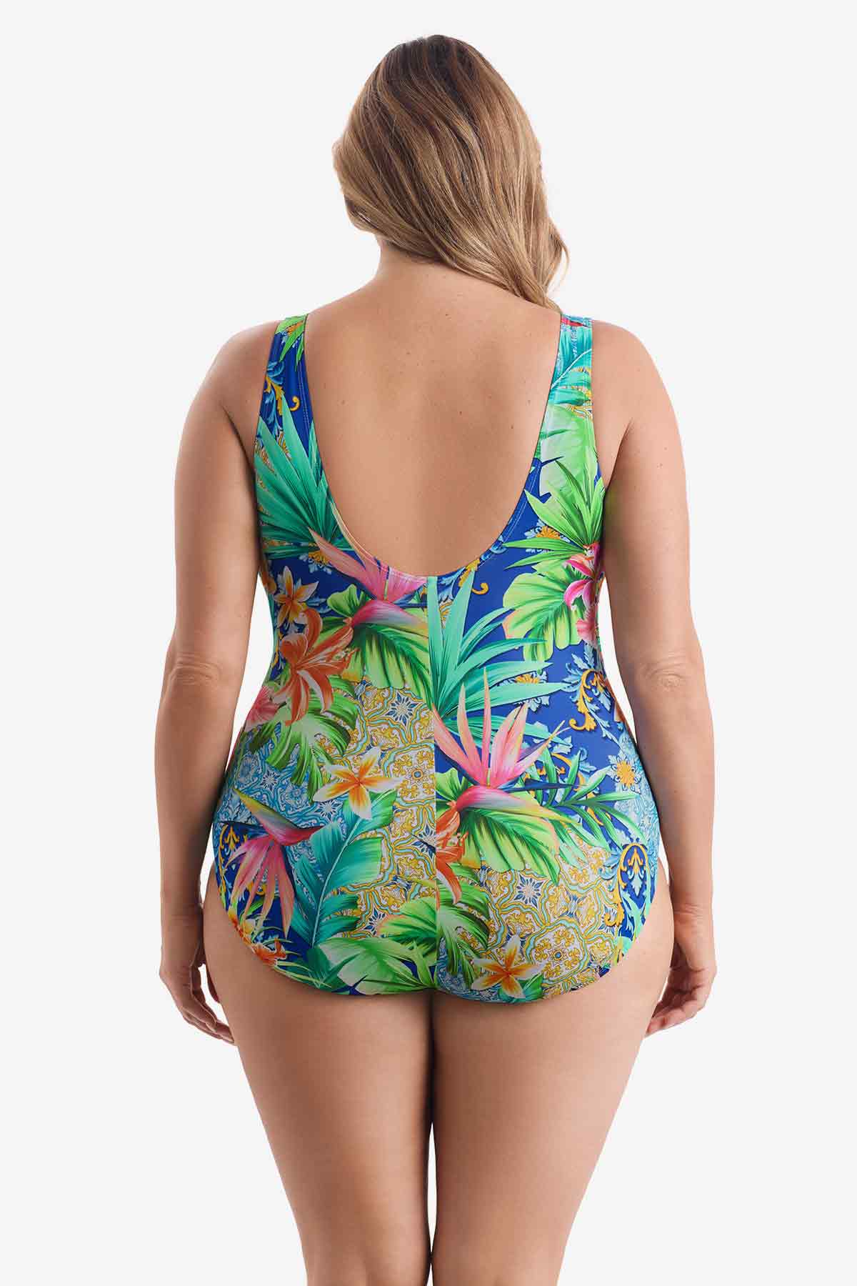 Woman faced away wearing a multicolored tropical printed one-piece swimsuit