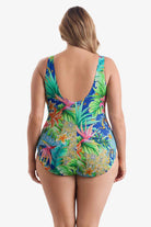 Woman faced away wearing a multicolored tropical printed one-piece swimsuit