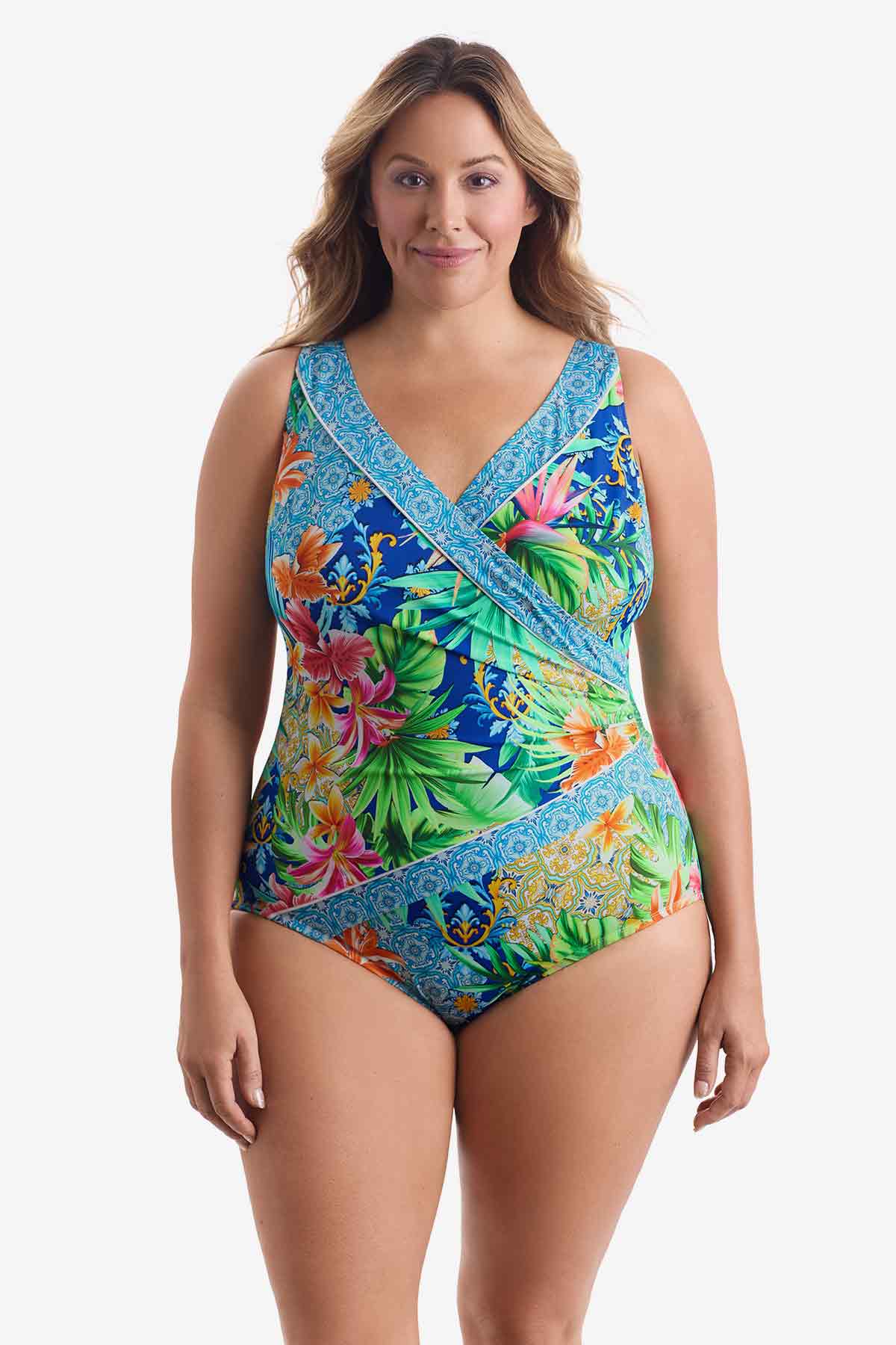 Woman wearing a multicolored tropical printed one-piece swimsuit