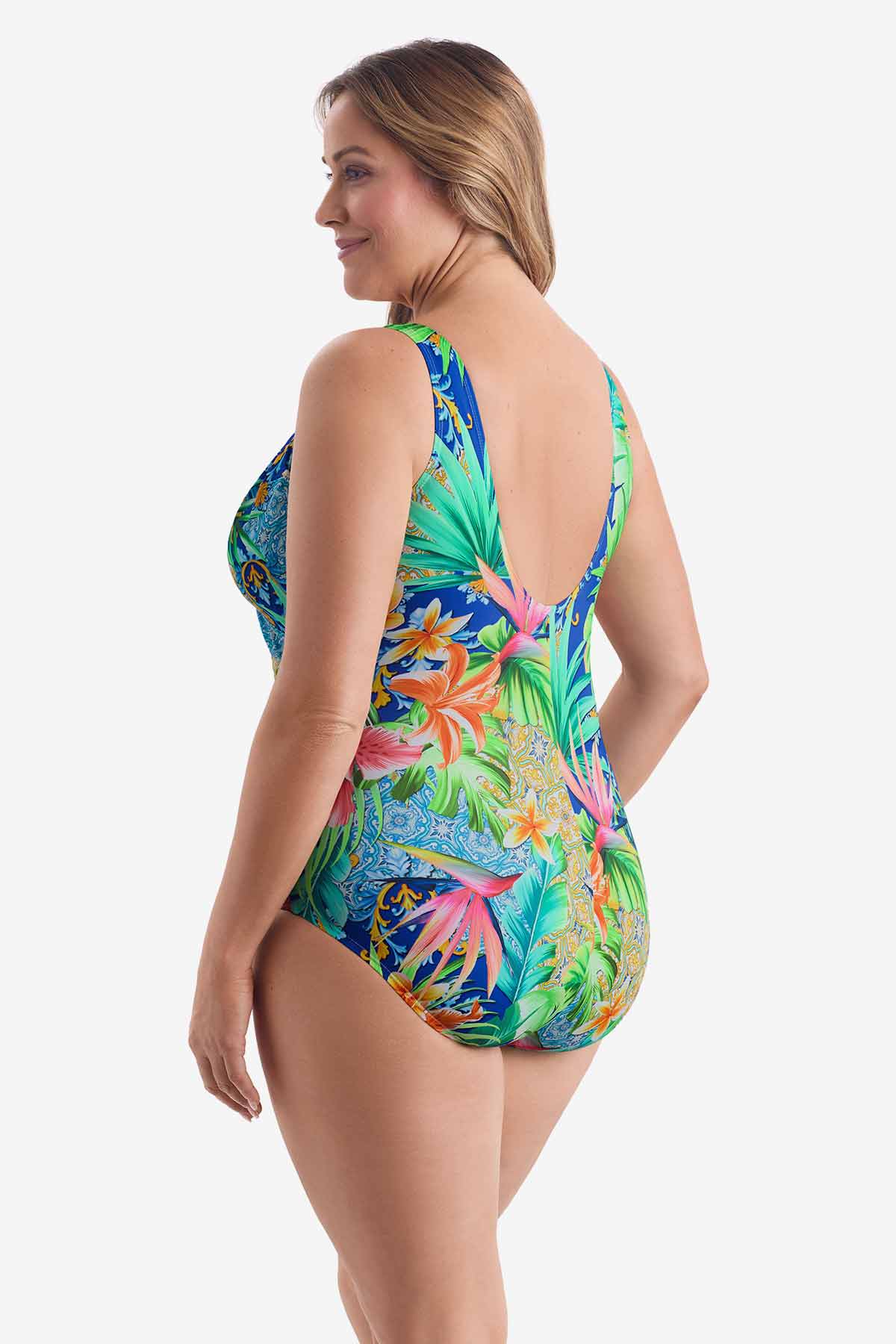 Woman turned left wearing a multicolored tropical printed one-piece swimsuit