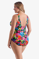 Woman turned left wearing a multicolored floral one-piece swimsuit 