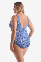 Woman turned left wearing blue and white fine china printed one-piece swimsuit with ruffles on the neckline