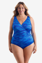 Woman wearing a blue paint brush pattern one-piece swimsuit with an O ring on the side