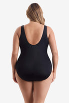 Woman faced away wearing a black one-piece swimsuit