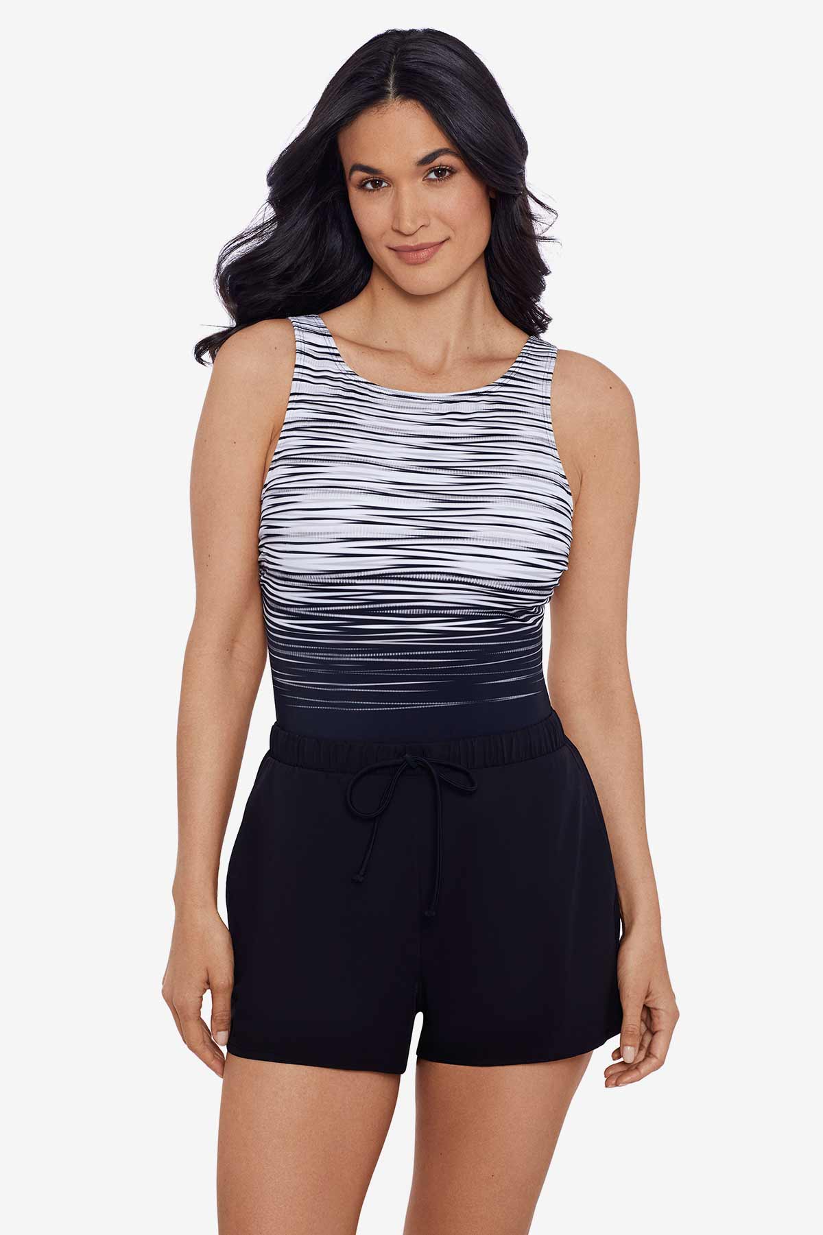 Woman wearing a black and white stripey pattern one-piece romper swimsuit