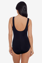 Woman turned away wearing a black one-piece swimsuit