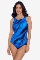 Woman wearing a black and blue oil slick printed one-piece swimsuit