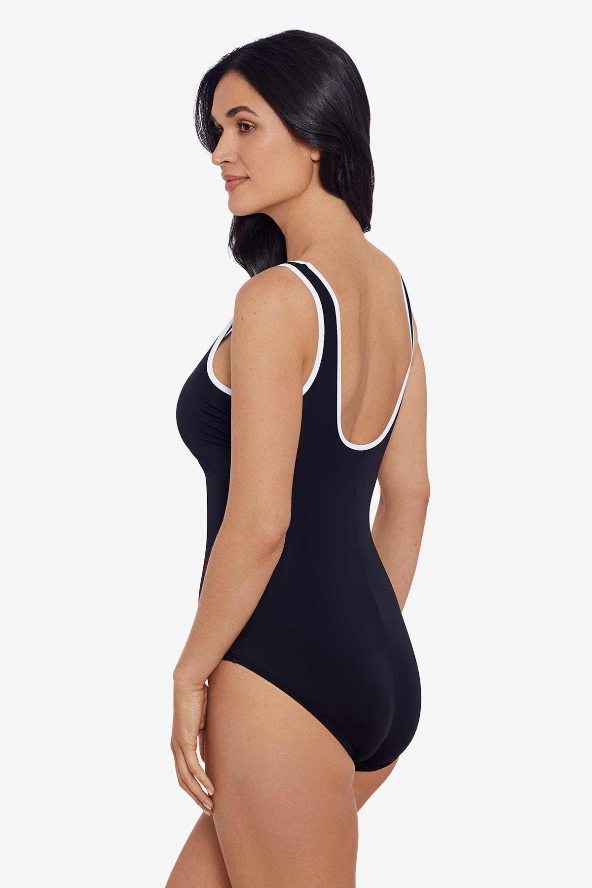 Woman faced left wearing a black one-piece swimsuit with white piping on the straps