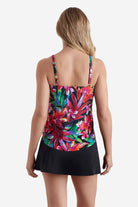 Woman faced away wearing a tankini top with a multicolored floral print