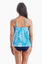 Woman faced away wearing a tankini top with an abstract blue pattern