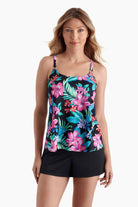 Woman wearing a tankini top with a multicolored floral print