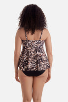 Woman turned away wearing a brown butterfly wing printed tankini top