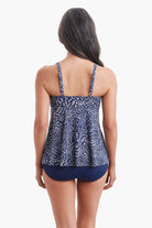 Woman faced away wearing a tankini top with a navy and white print