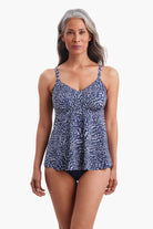 Woman wearing a tankini top with a navy and white print