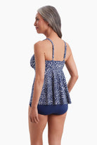 Woman faced left wearing a tankini top with a navy and white print