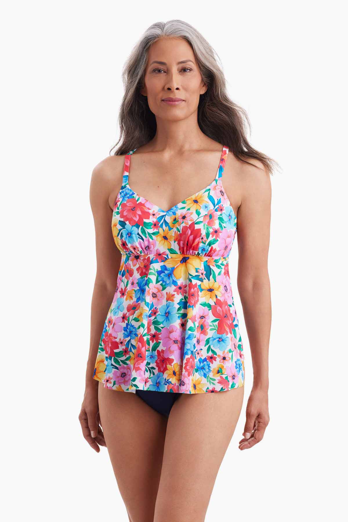 Woman wearing a tankini top with a multicolored floral pattern