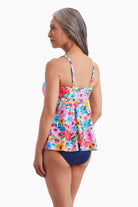 Woman turned left wearing a tankini top with a multicolored floral pattern
