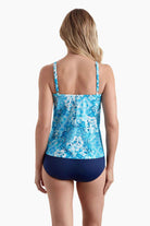 Woman turned away wearing a  tankini top with an abstract blue pattern