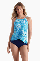 Woman wearing a highneck tankini top with an abstract blue pattern