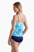 Woman turned left wearing a tankini top with an abstract blue pattern