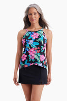 Woman wearing a tankini top with a multicolored floral print