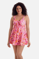 Woman wearing a pink floral printed swim dress 