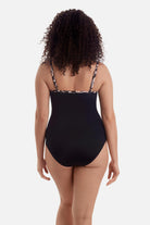 Woman turned away wearing a brown butterfly wing printed one-piece swimsuit 