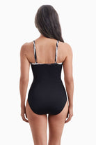Woman faced away wearing a one-piece swimsuit
