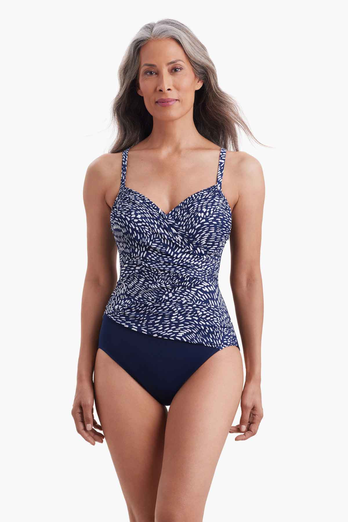 Woman wearing a one-piece swimsuit with a blue and white print