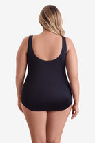 Woman faced away wearing a one-piece swimsuit