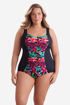 Woman wearing a multicolored floral print down the middle of the one-piece swimsuit