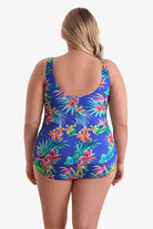 Woman faced away wearing a multicolored palm leaf tropical printed one-piece swimsuit