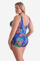 Woman turned left wearing a multicolored palm leaf tropical printed one-piece swimsuit