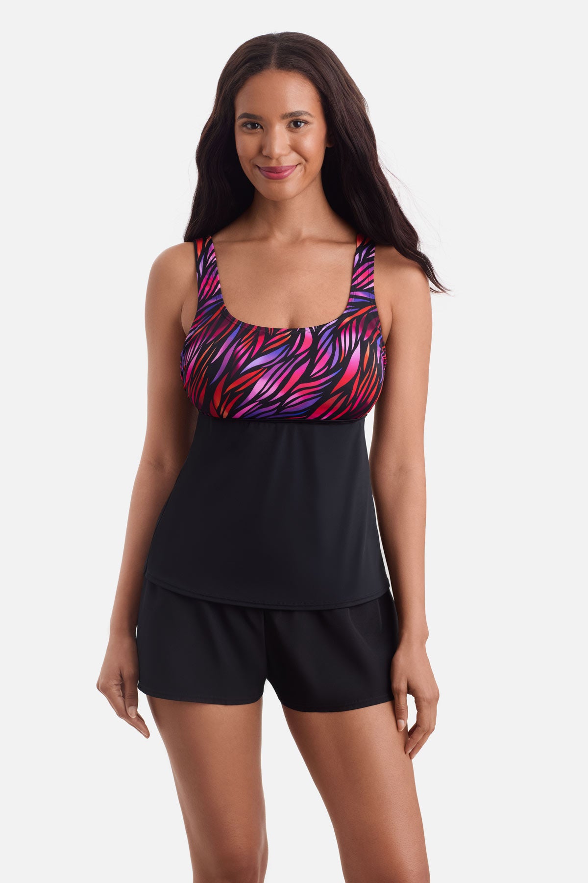 Woman wearing a tankini swim top with a pink pattern on the bust
