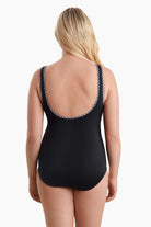 Woman faced away to show black and white trim detail in the back