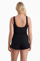 Woman turned away to show off back of swimsuit