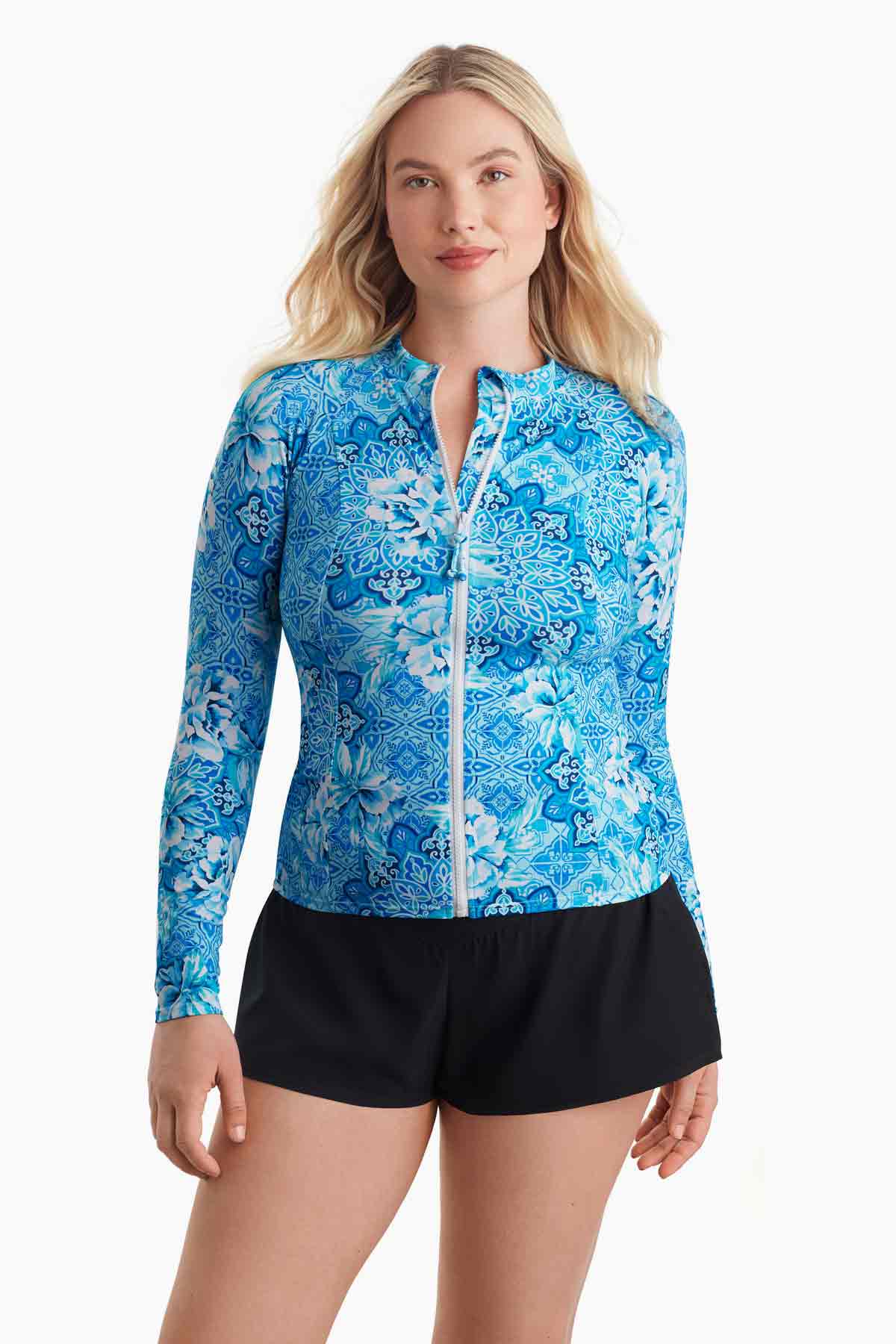 Woman wearing a blue abstract printed sun shirt with a zipper down the front
