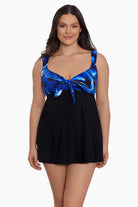 Woman wearing a blue and black oil slick printed bust swim dress