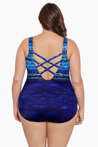 Woman faced away wearing a blue ombre abstract printed one-piece swimsuit and X back