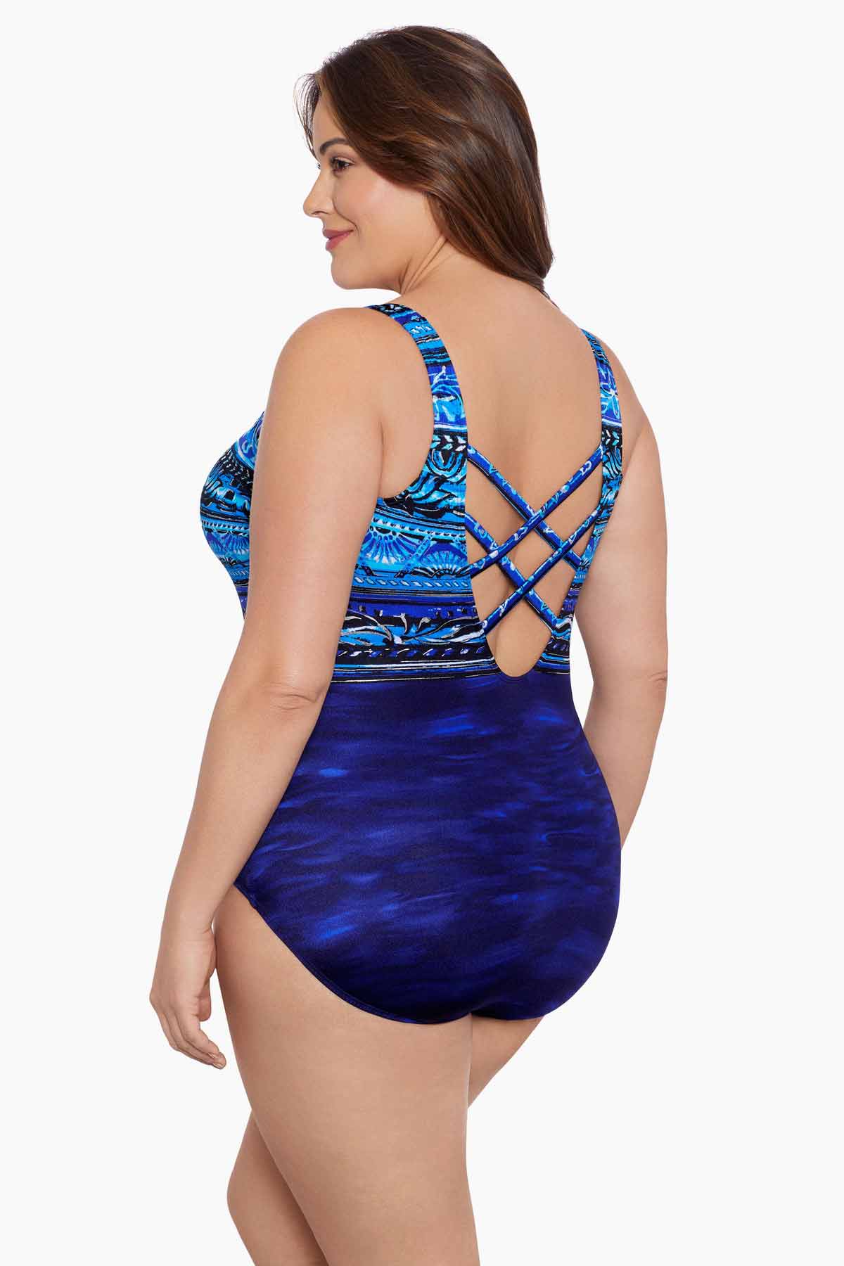 Woman faced left wearing a blue ombre abstract printed one-piece swimsuit