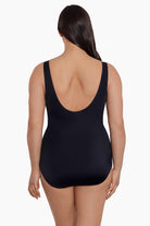 Woman faced away wearing a black swimsuit 