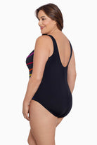 Woman turned left wearing a rainbow-streaked fan tank one-piece swimsuit