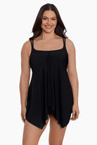 Woman wearing a black drapey swim dress