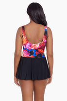 Woman faced away wearing a multicolored watercolor swim dress 