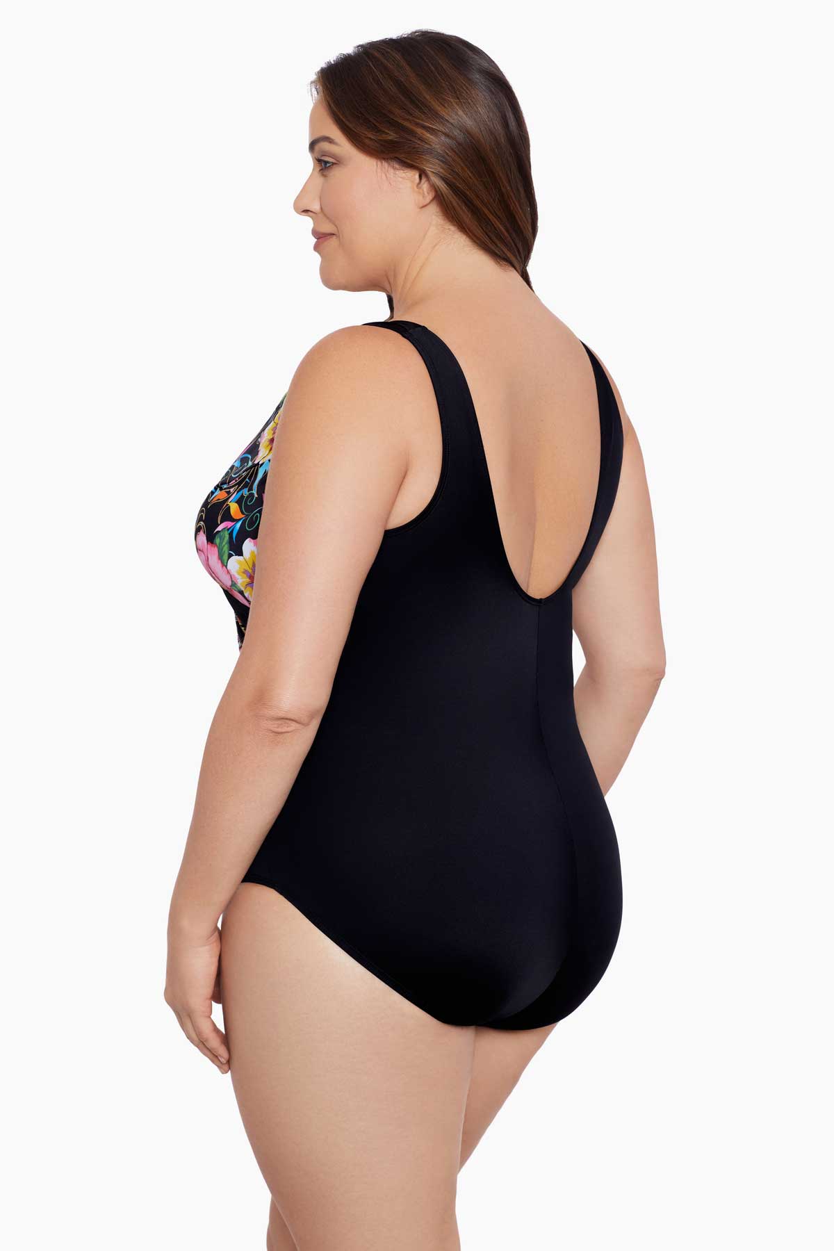 Woman turned left wearing a floral printed one-piece swimsuit with black blocking