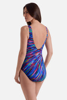 Woman turned left wearing a multicolor radial burst print one-piece swimsuit