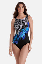 Woman wearing a zebra and floral printed one-piece swimsuit