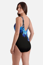 Woman turned left wearing a zebra and floral printed one-piece swimsuit