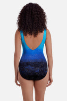 Woman turned away wearing a blue ombre one-piece swimsuit with shimmer detail