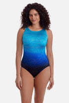 Woman wearing a blue ombre one-piece swimsuit with shimmer detail
